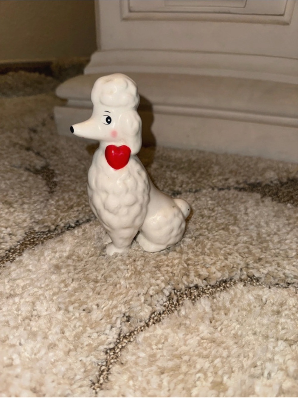 White poodle figurine with red heart